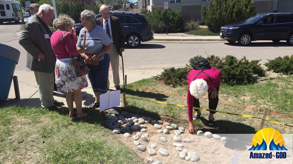 Barb Wilson placing living stone on pathway
