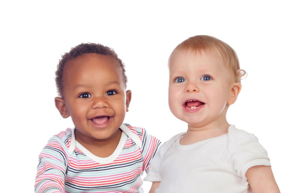 African American and White babies in t shirts sitting together.
