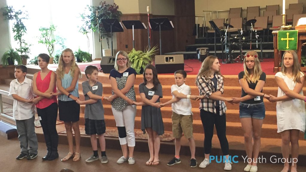 Members of Parker UMC youth group holding hands during their dance flash mob performance of "The River."