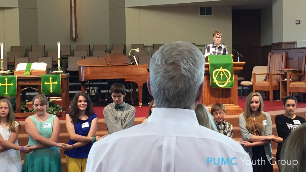 Members of Parker UMC youth group holding hands during their dance flash mob performance of "The River."