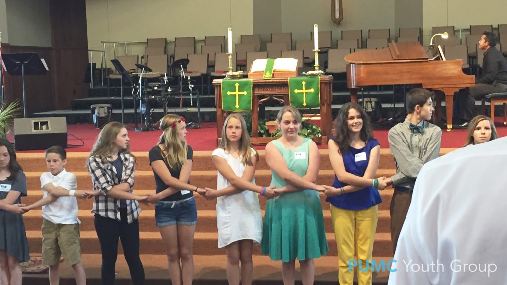 Members of Parker UMC youth group holding hands during their dance flash mob performance of "The River."