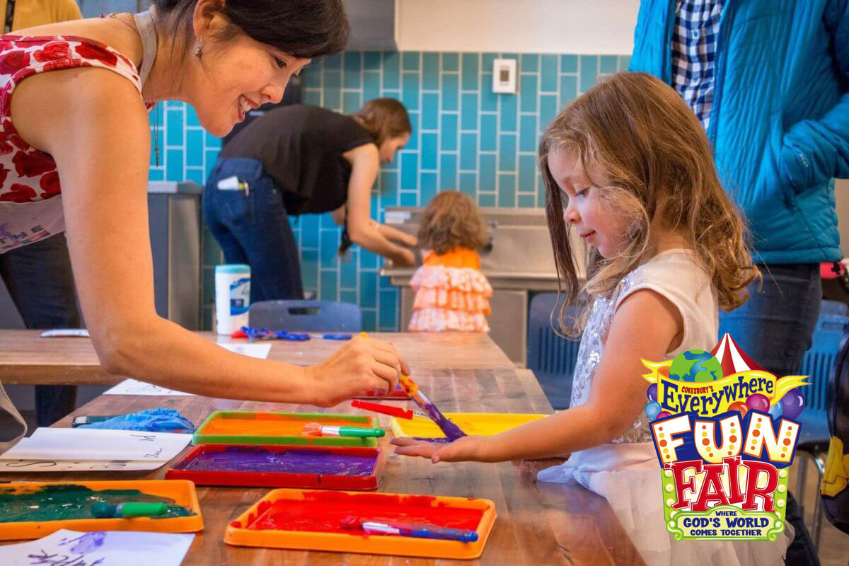 Photo of teacher helping child with art craft