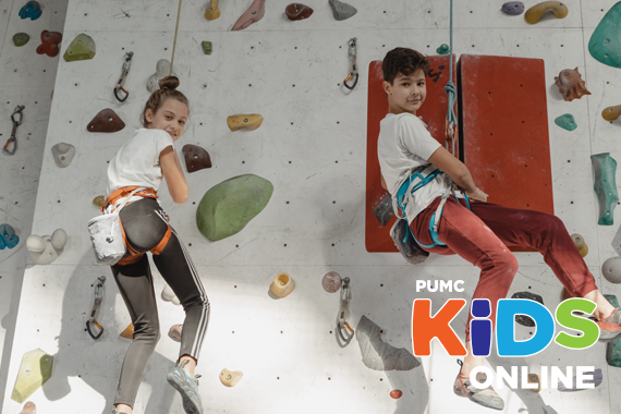 Kids climbing indoor rock wall.